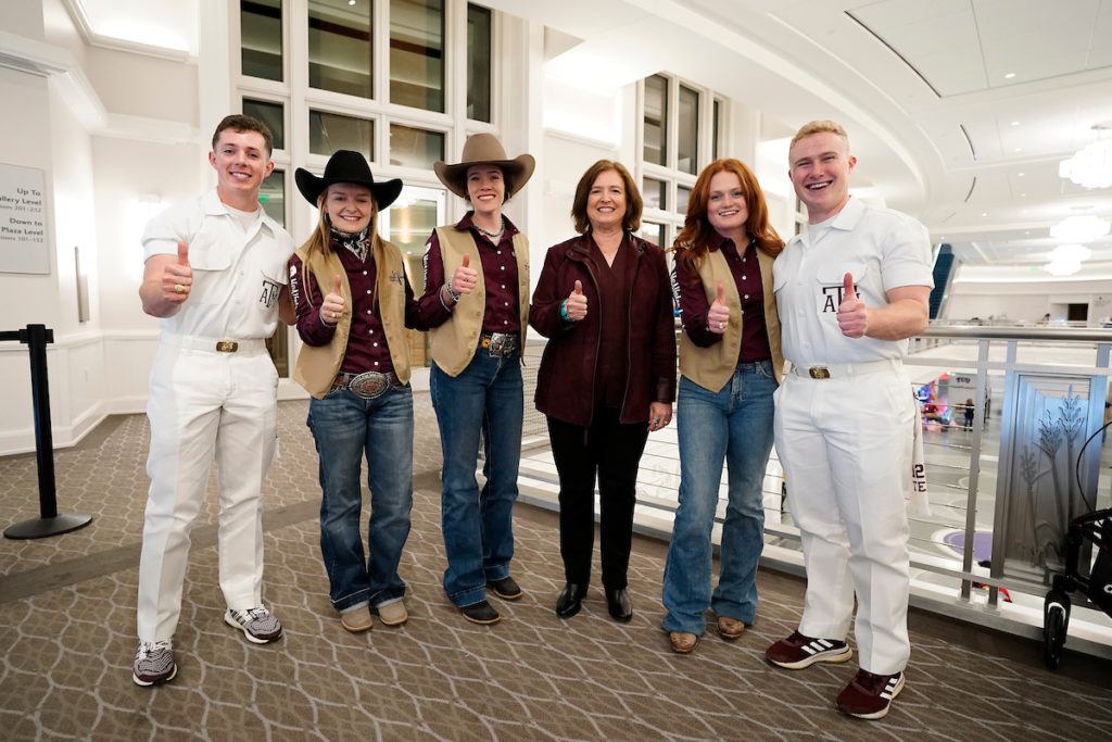 President M. Katherine Banks with rodeo participants and Yell Leaders