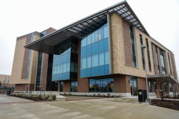 The north entrance of ILSQ next to Old Main Drive, with the adjacent ILCB pictured in the background on the other side of Wellborn Road.