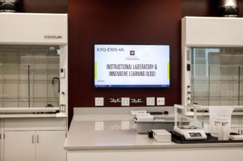 A look at one of the work stations inside ILSQ’s organic chemistry labs, equipped with a computer, fume hoods and assorted lab equipment.