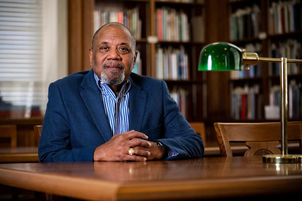 Portrait of Fred McClure seated at a table in Cushing Library
