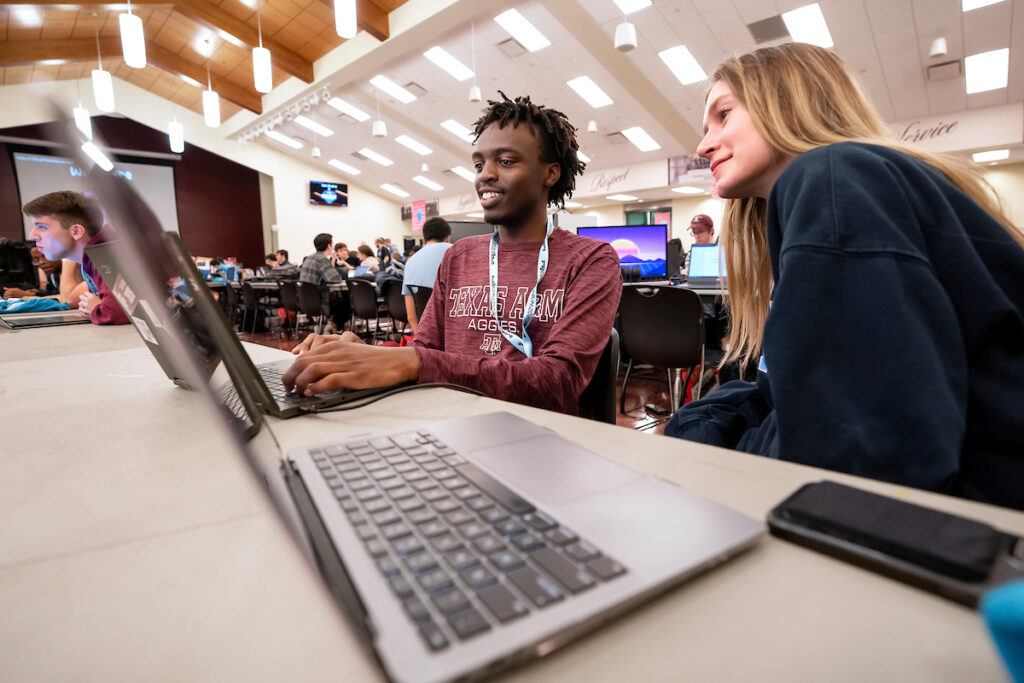 Two college students discuss creating a game at the Chillennium game jam.