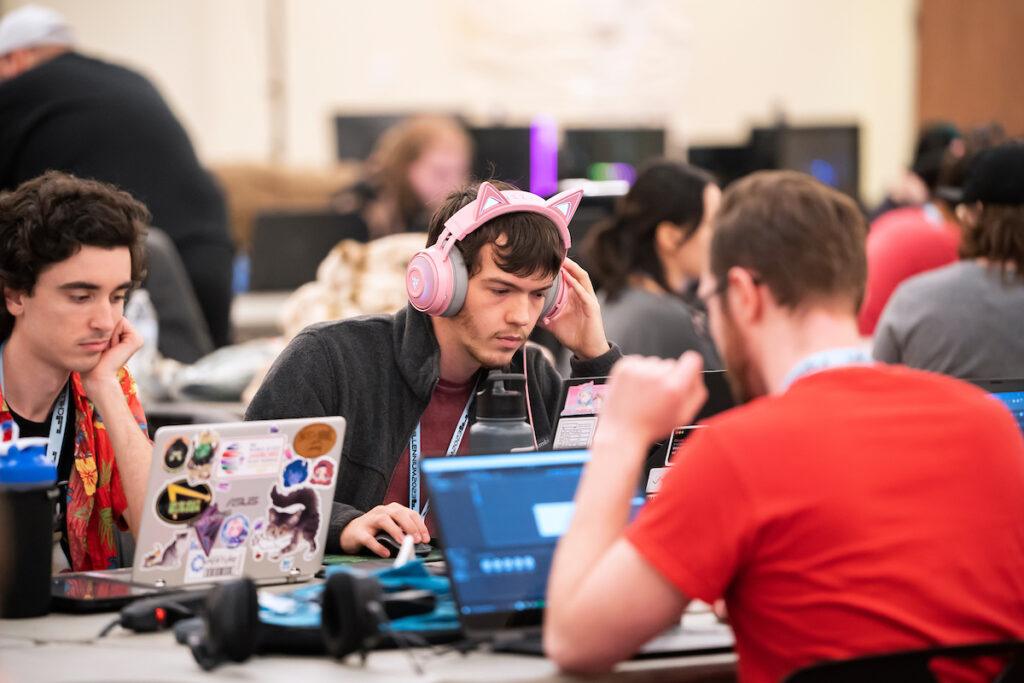 Three college students work on creating a game at the Chillennium game jam.