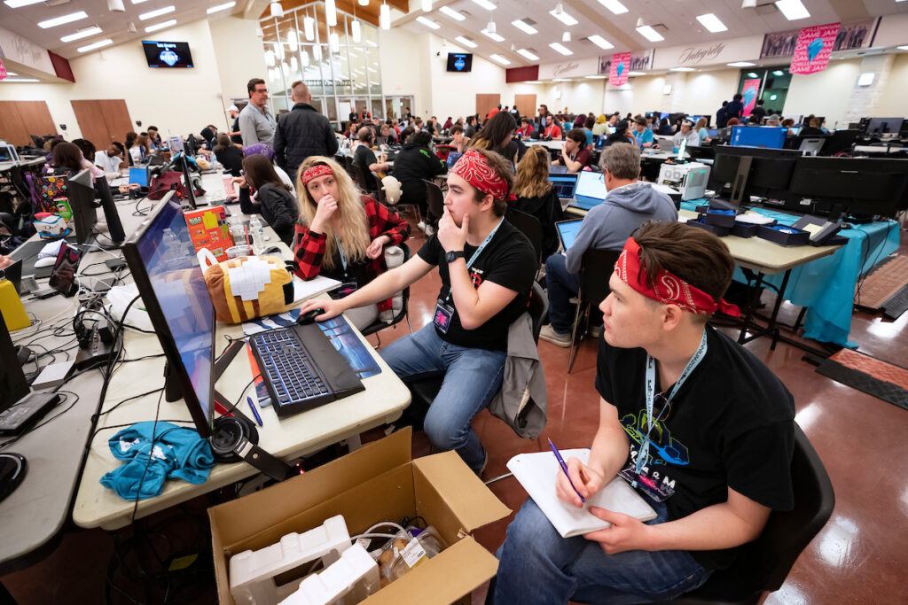 Three college students work on developing a game at the Chillennium game jam.