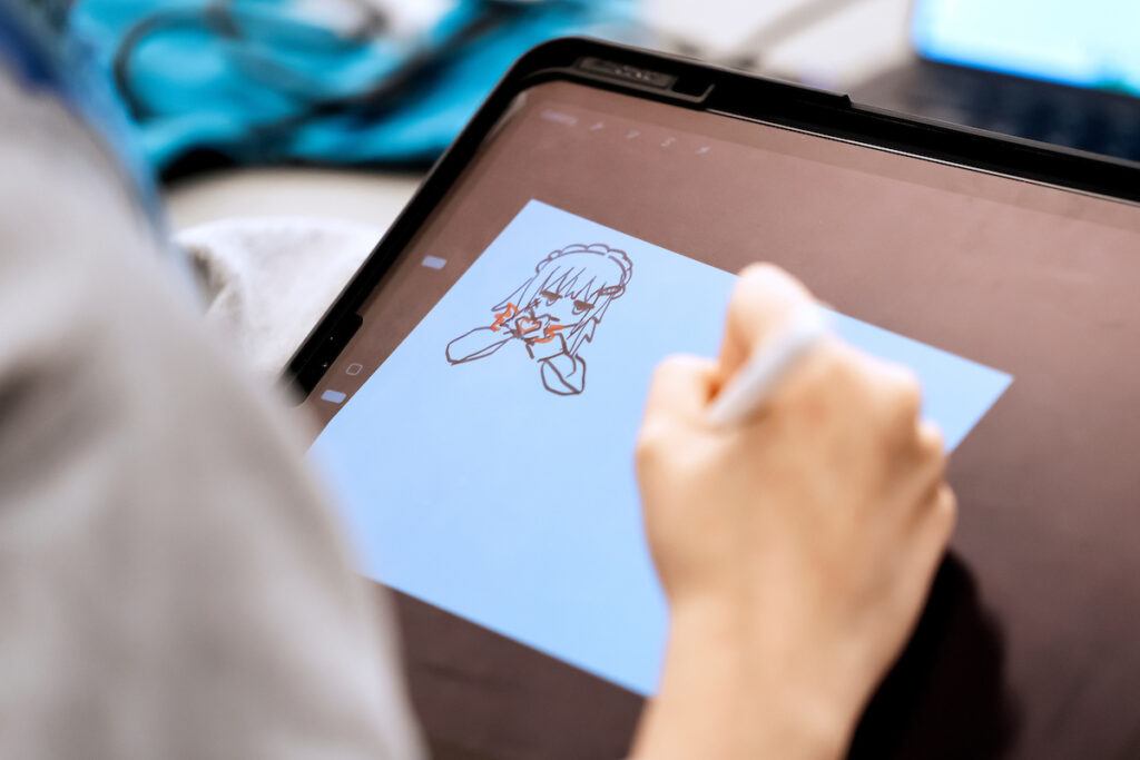 A college student works on drawing a character for a game at the Chillennium game jam.
