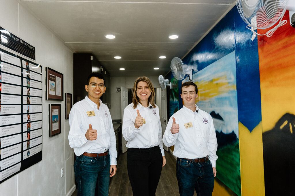 BUILD Chief Operating Officer Chase Parrish '24, Chief Financial Officer Albert Tran '24 and Chief Executive Officer Kate-Riley Rogers stand inside of the Ukraine TAMC
