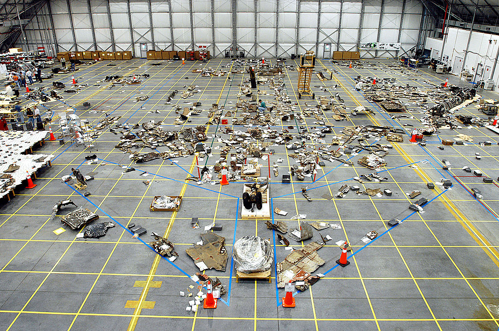 Debris spread across the floor of a NASA hangar