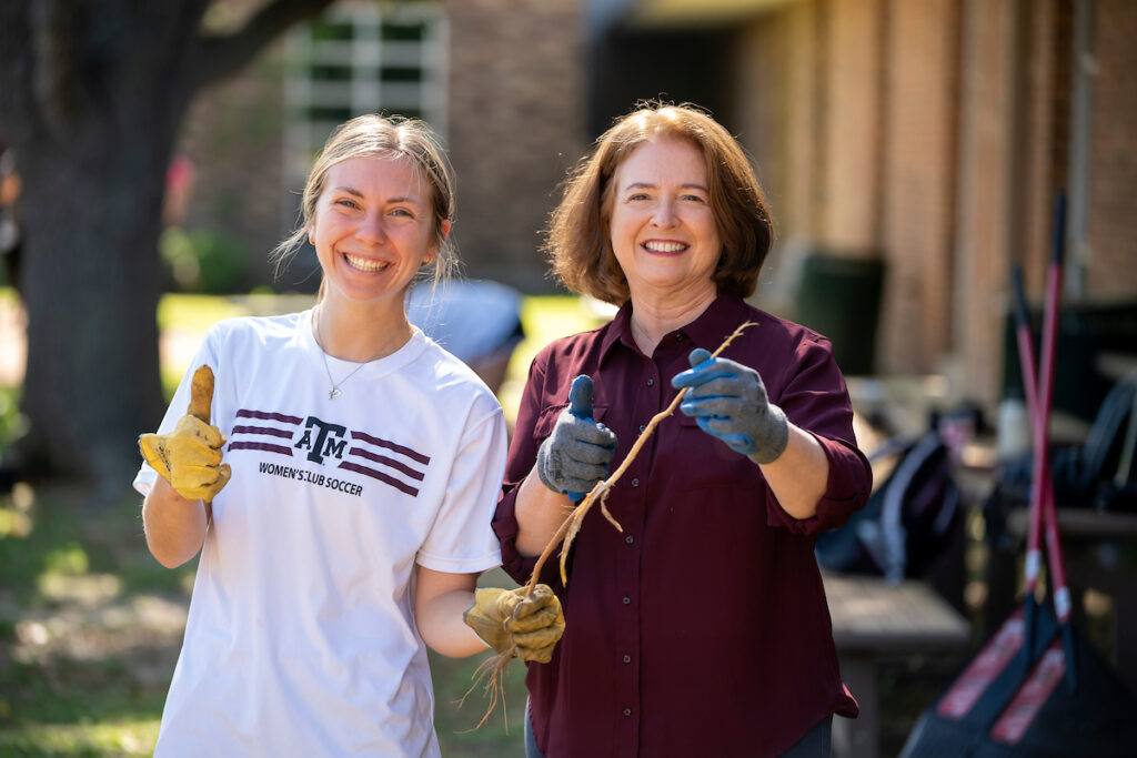 President M. Katherine Banks posing with a student at a job site