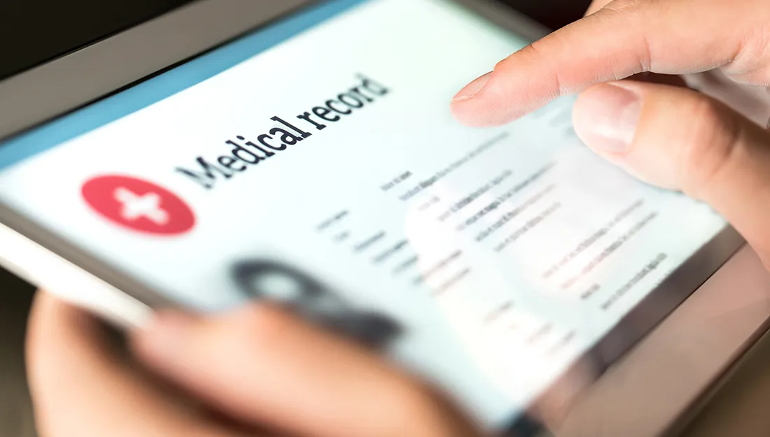 a person holding a screen that says medical records