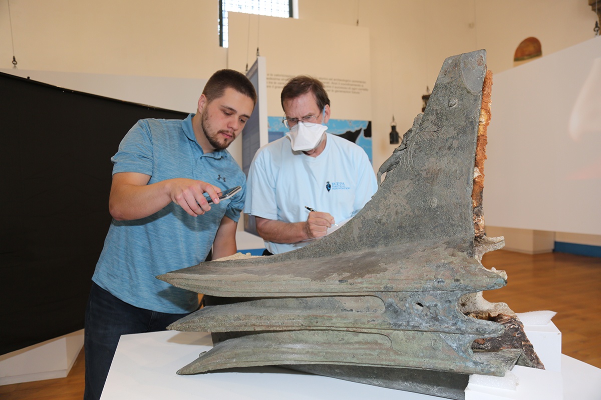 Summer 2022, Stephen DeCasien in Sicily studying a naval ram from the Battle of Egadi Islands Project