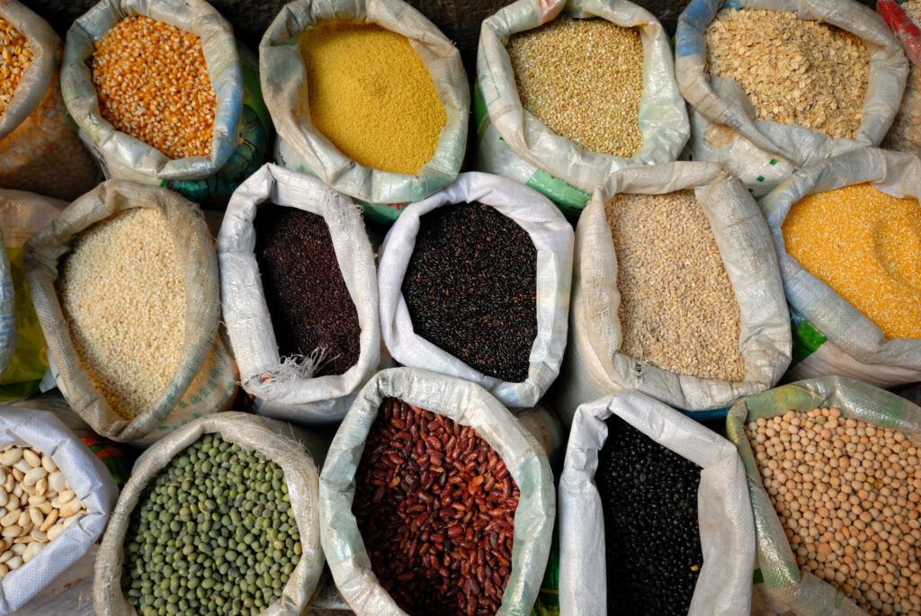 a photo of a bunch of open sacks with various grains and other foodstuffs