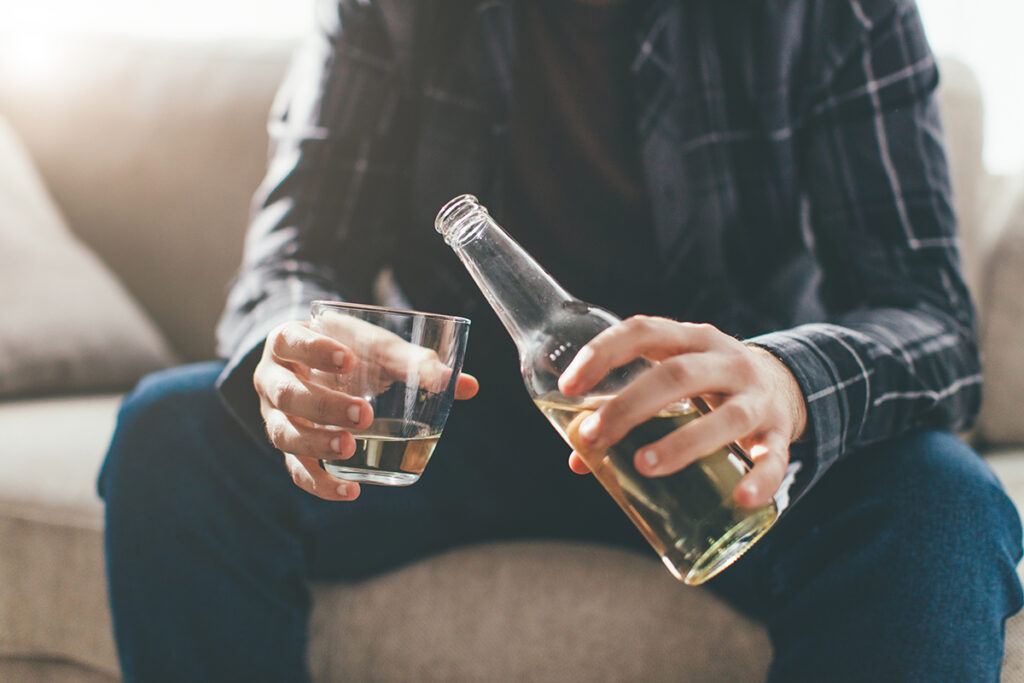 man pouring alcohol