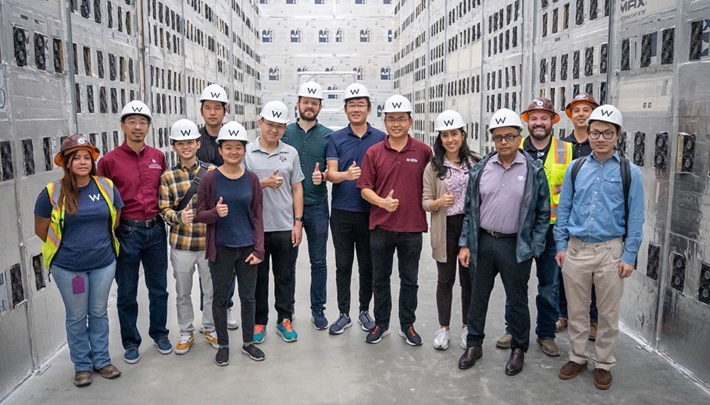 The Texas A&M Blockchain and Energy Consortium team pose in a crypto mining facility