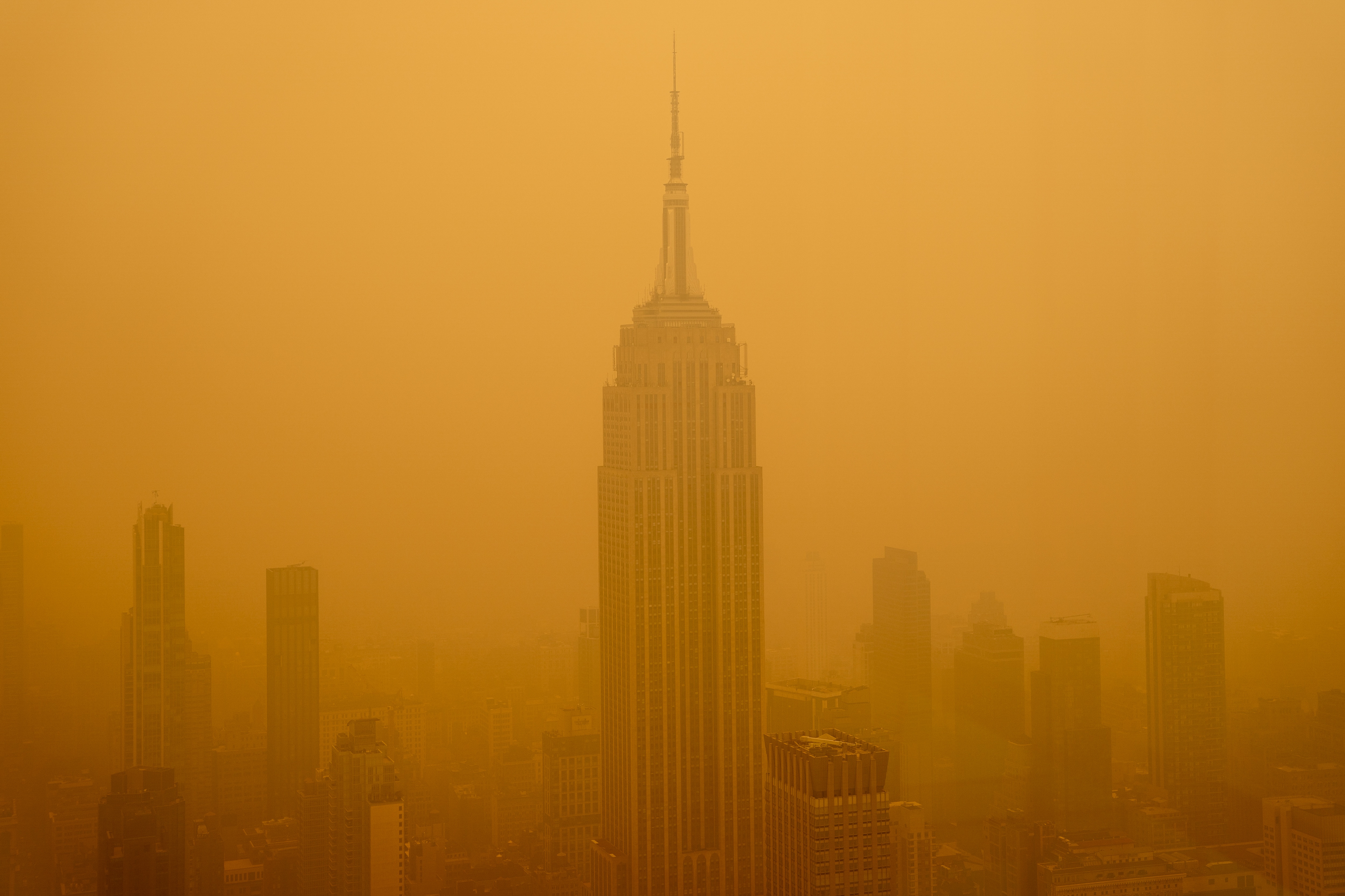 Smoky haze from wildfires in Canada diminishes the visibility of the Empire State Building