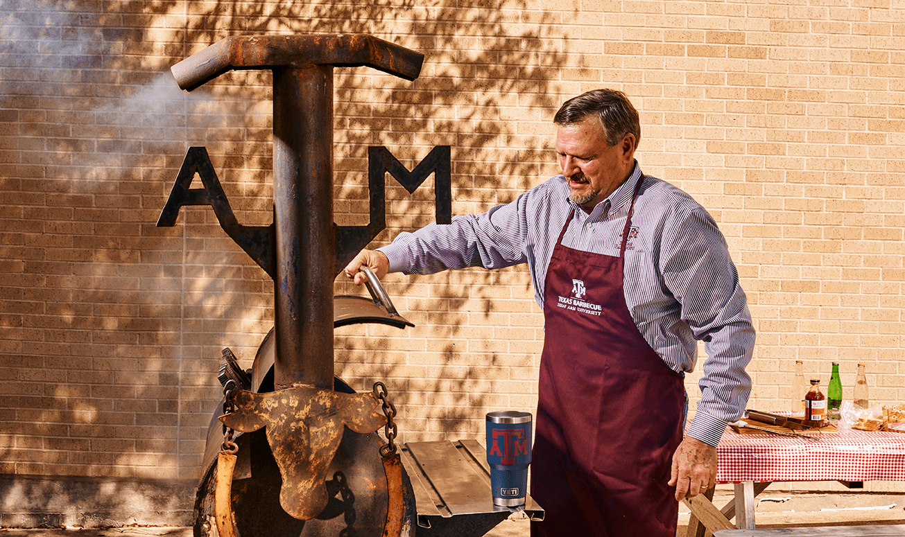 Ray Riler barbecuing on a pit