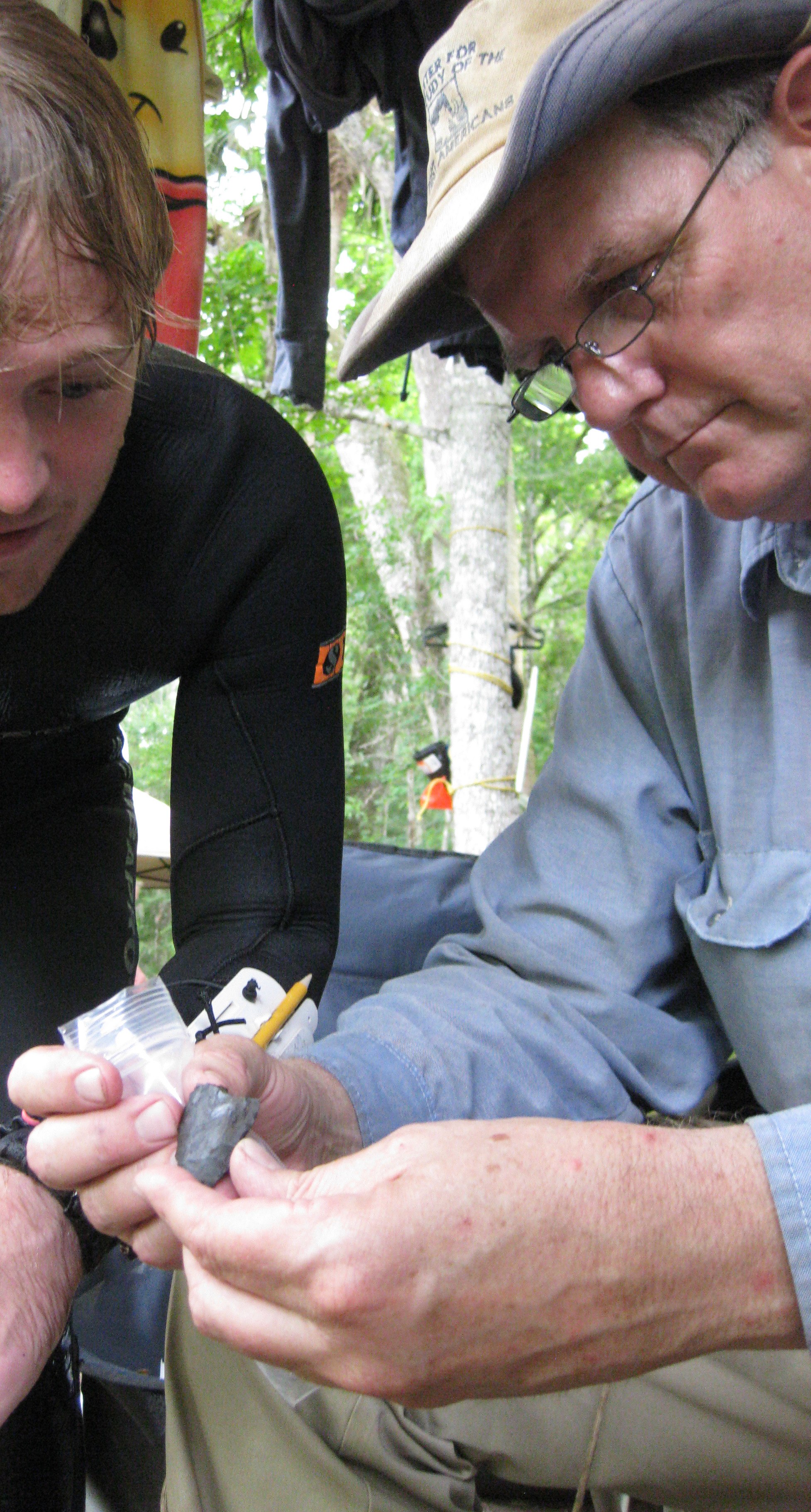 Dr. Waters and a grad student studying an unearthed artifact