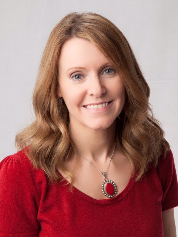 a portrait photo of a woman in a red shirt