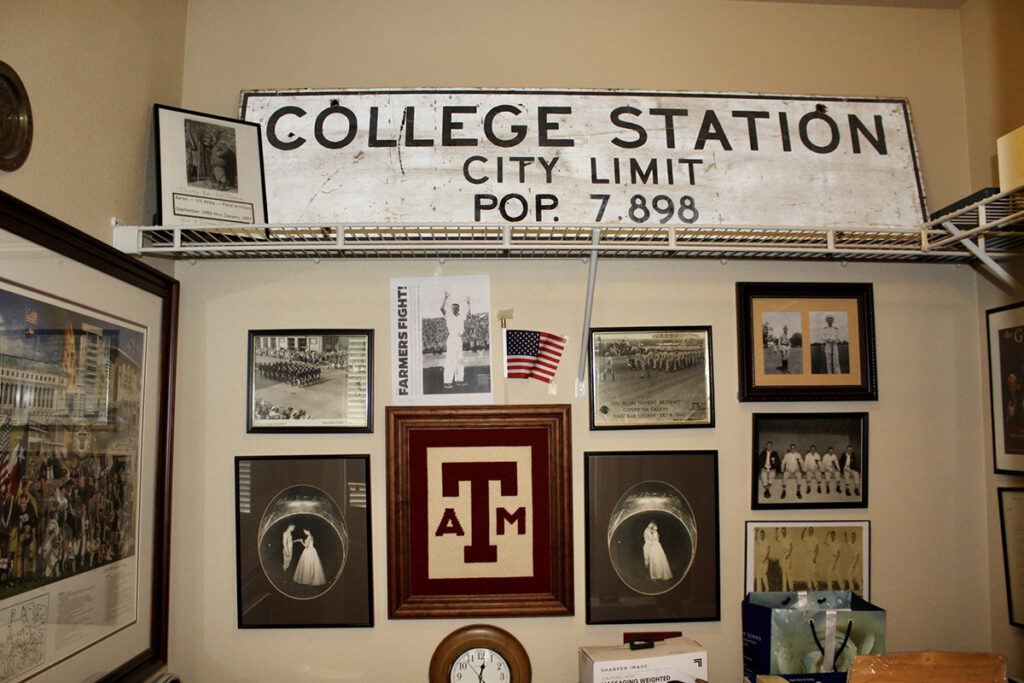 A snapshot of Tyree's collection of Aggie memorabilia. His collection includes photos of himself as a Yell Leader, posters and a College Station road sign.