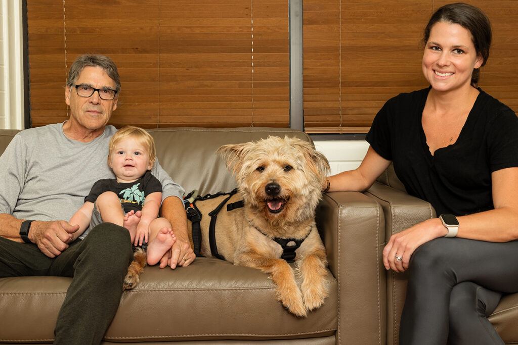 Rick Perry '72 with his grandson, Scout the dog, and Sydney Perry