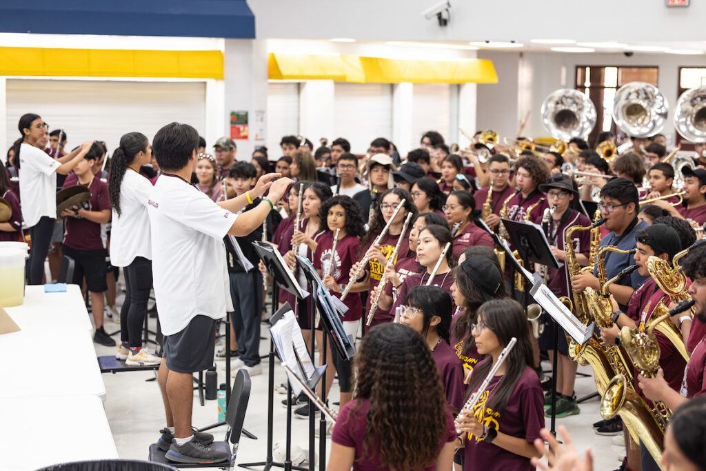 a photo of a large group of young people playing instruments