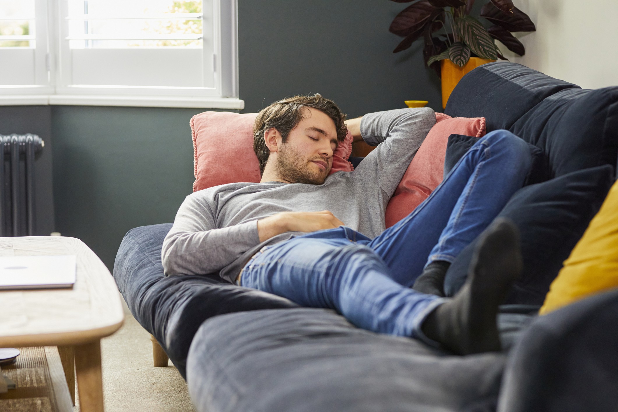 Young man asleep on a couch