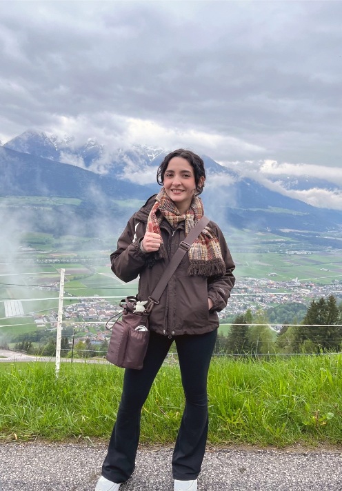 Senior meteorology major Taylor Peña ’22 with the Alps behind her
