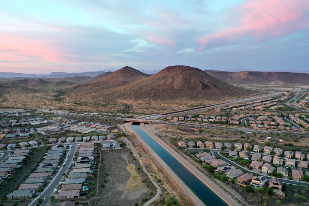 Aerial view of an Arizona suburb with a canal running past homes