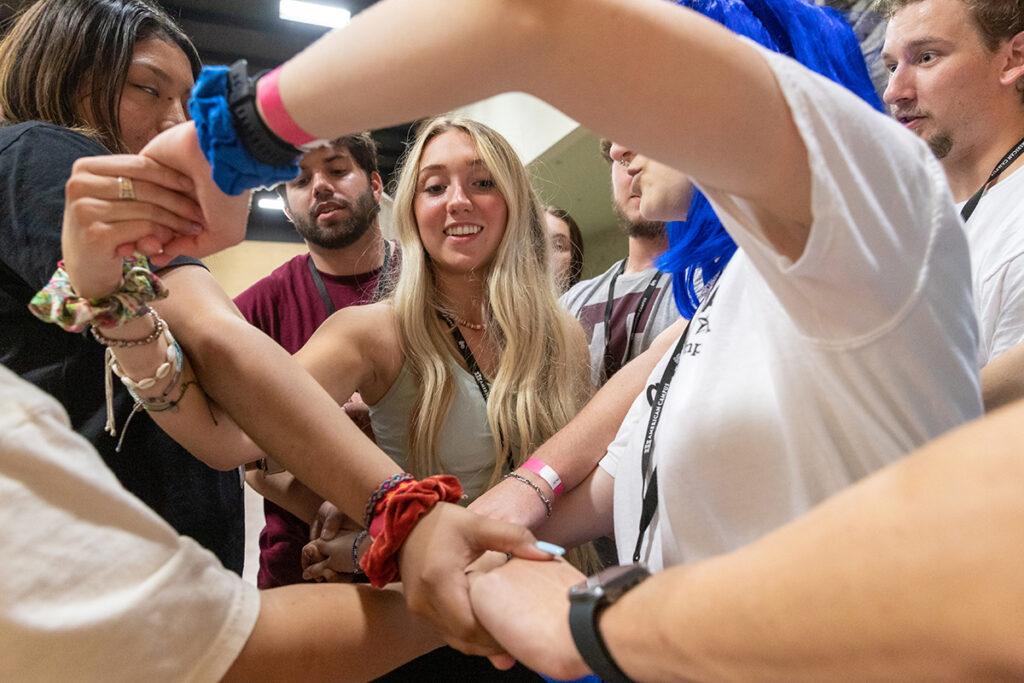 T-Camp attendees try to untangle themselves while playing the human knot game as an icebreaker in 2021.