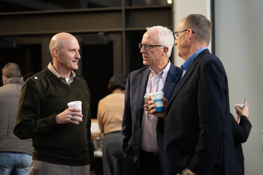 a photo of three men in outside Rudder Theatre.