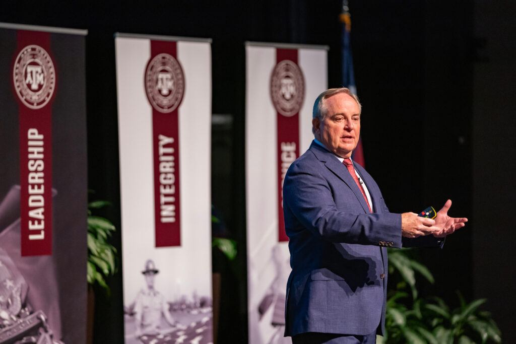 a photo of Mark A. Welsh III speaking onstage at Rudder Theatre