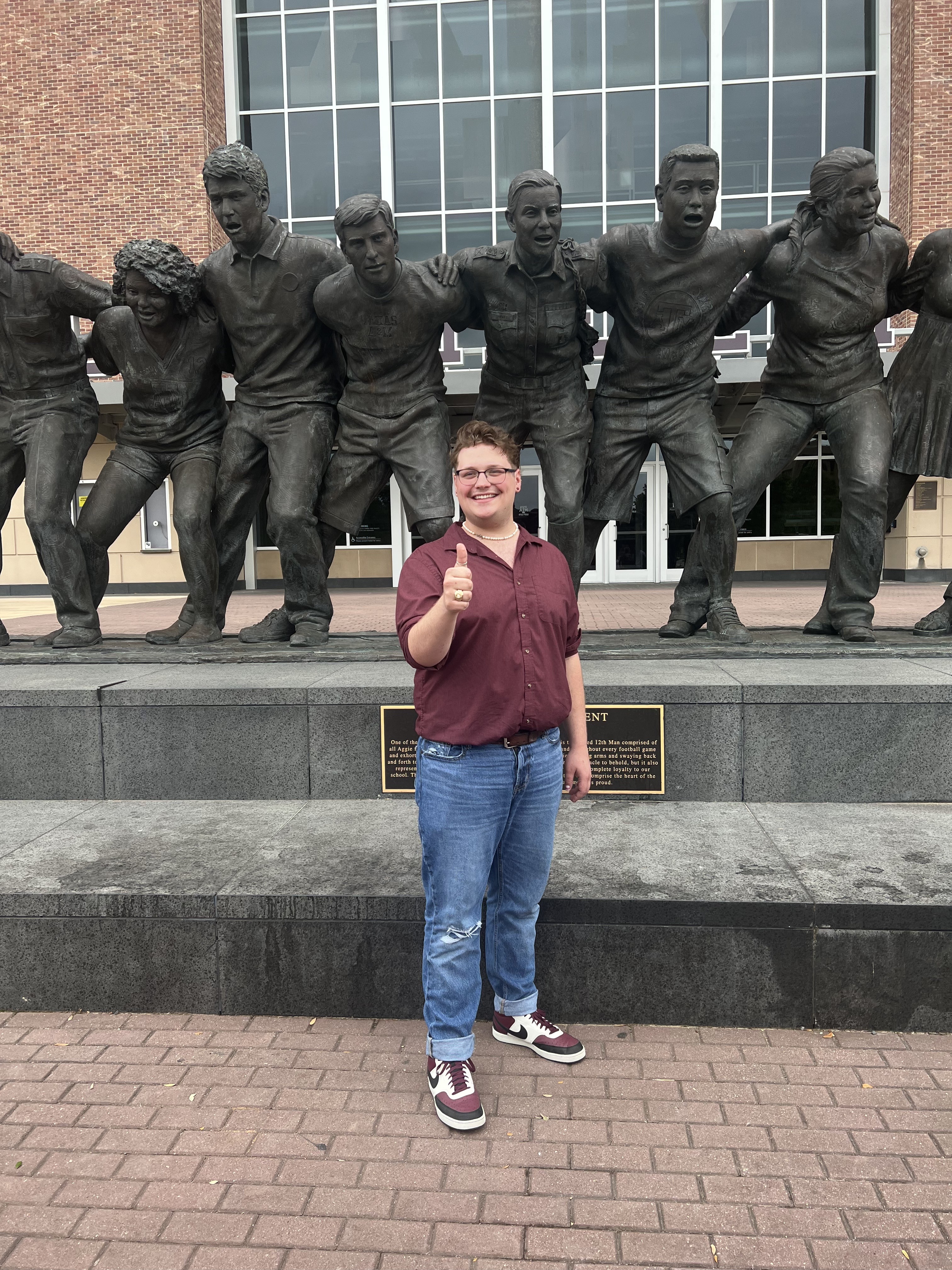 Canaan Hatfield standing in front of the War Hymn statue