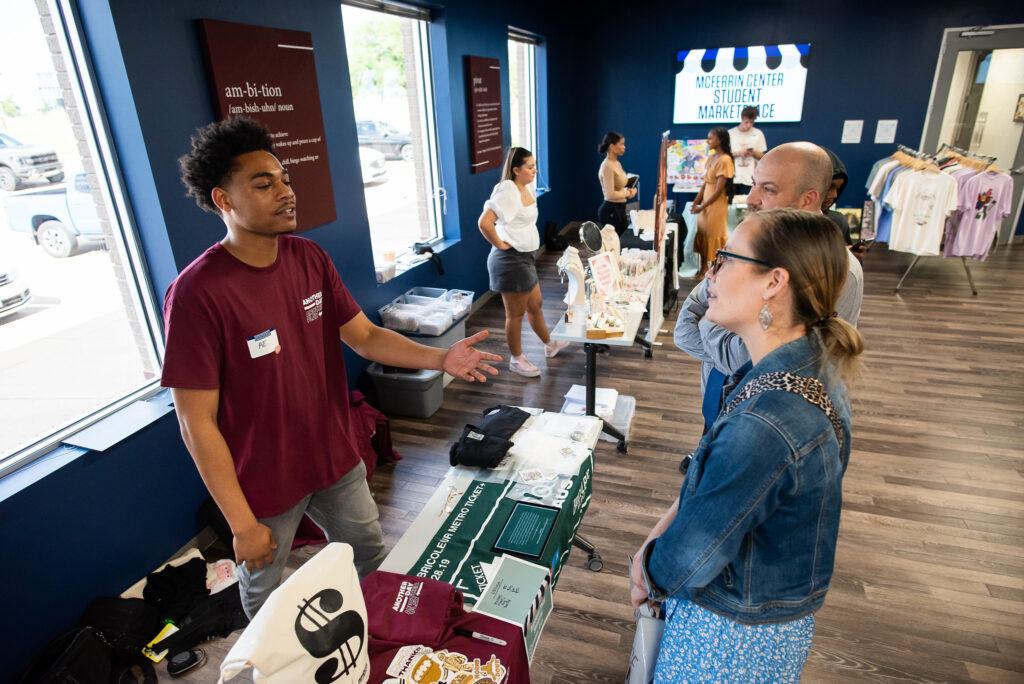 a student entrepreneur talking to a customer at the 2022 marketplace event