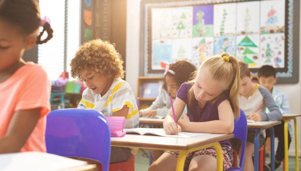 elementary school children sitting at their desks