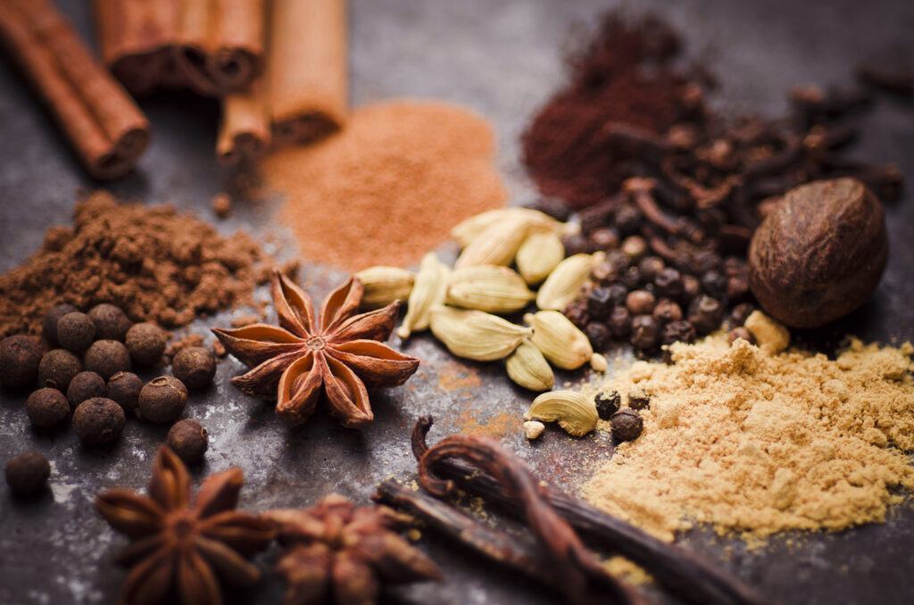 cinnamon sticks and other gingerbread spices on a table