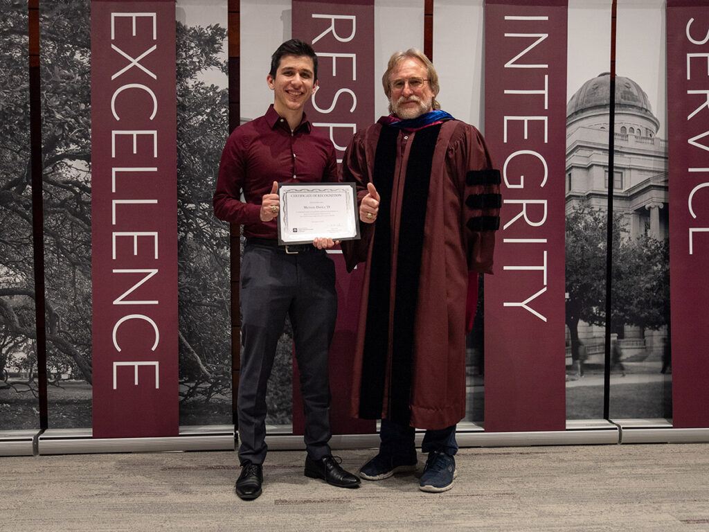 Michael Davila '23 and Professor Andrew Conkey at a graduation celebration at the McAllen campus