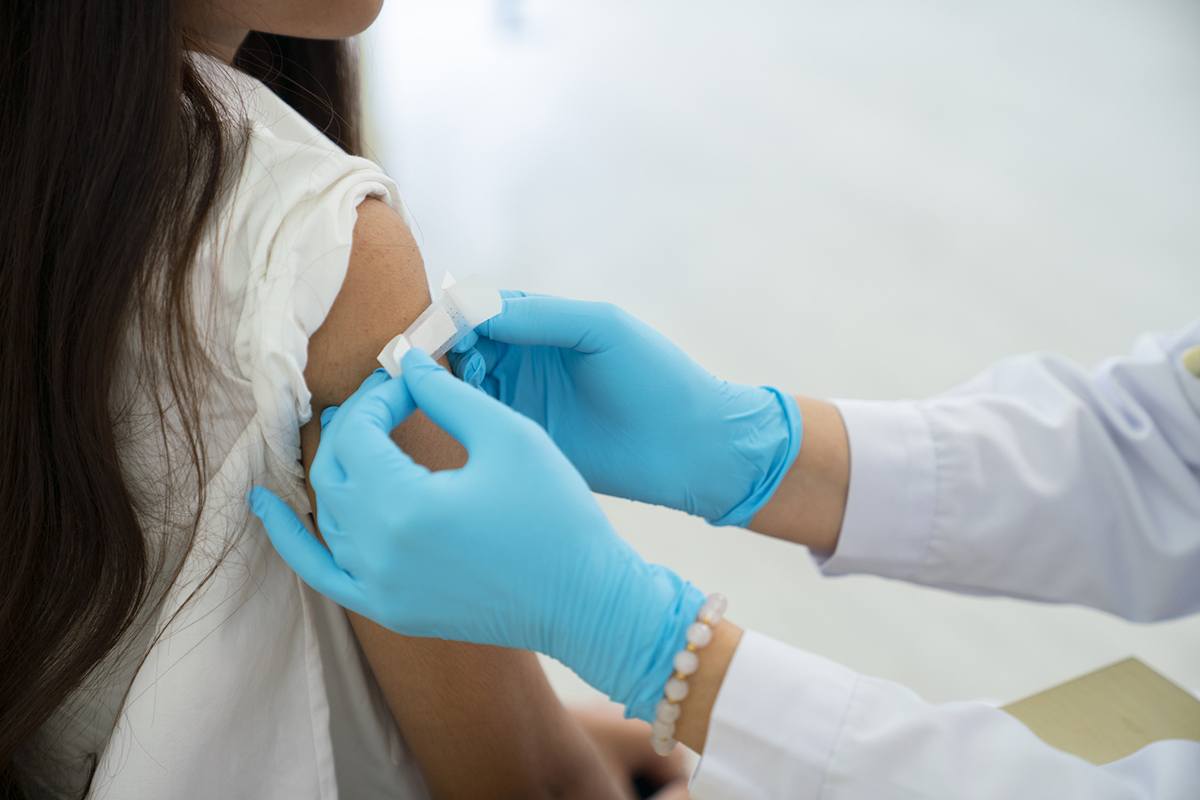 a health professional putting a bandage on a child's arm