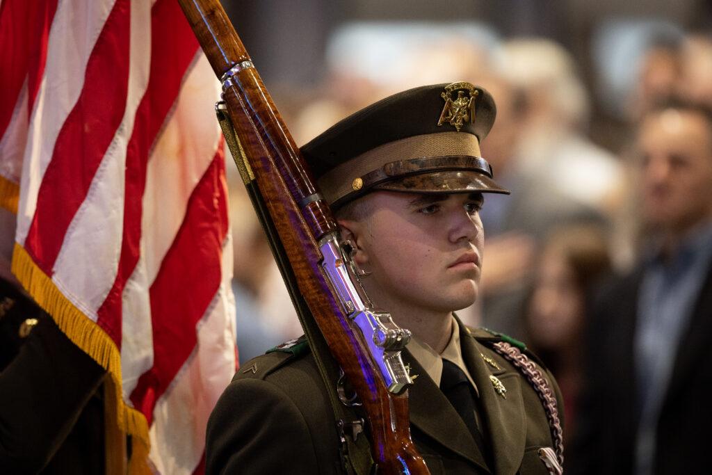 A photo of a Texas A&M University cadet with a rifle over his shoulder.