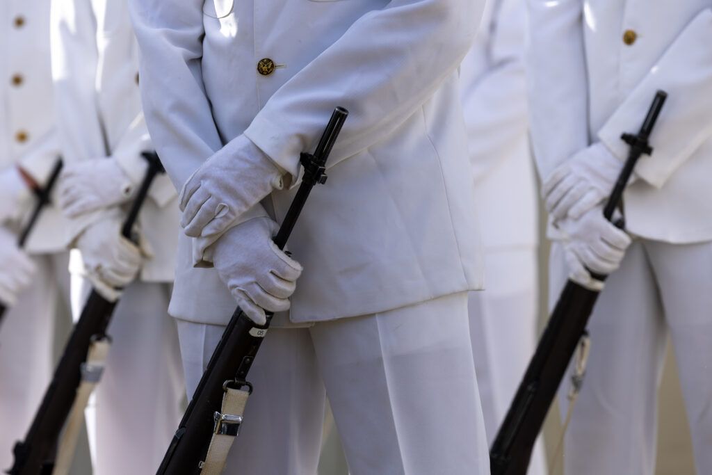 A photo of the hands of a Ross Volunteer holding a rifle.