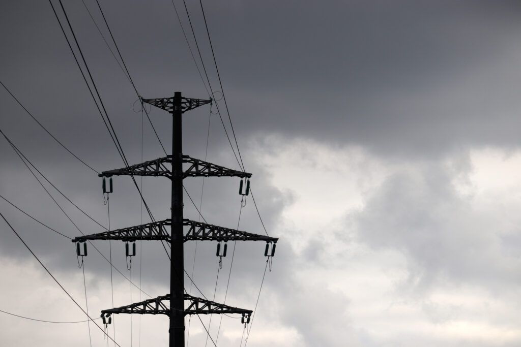 Power lines against a dark, cloudy sky