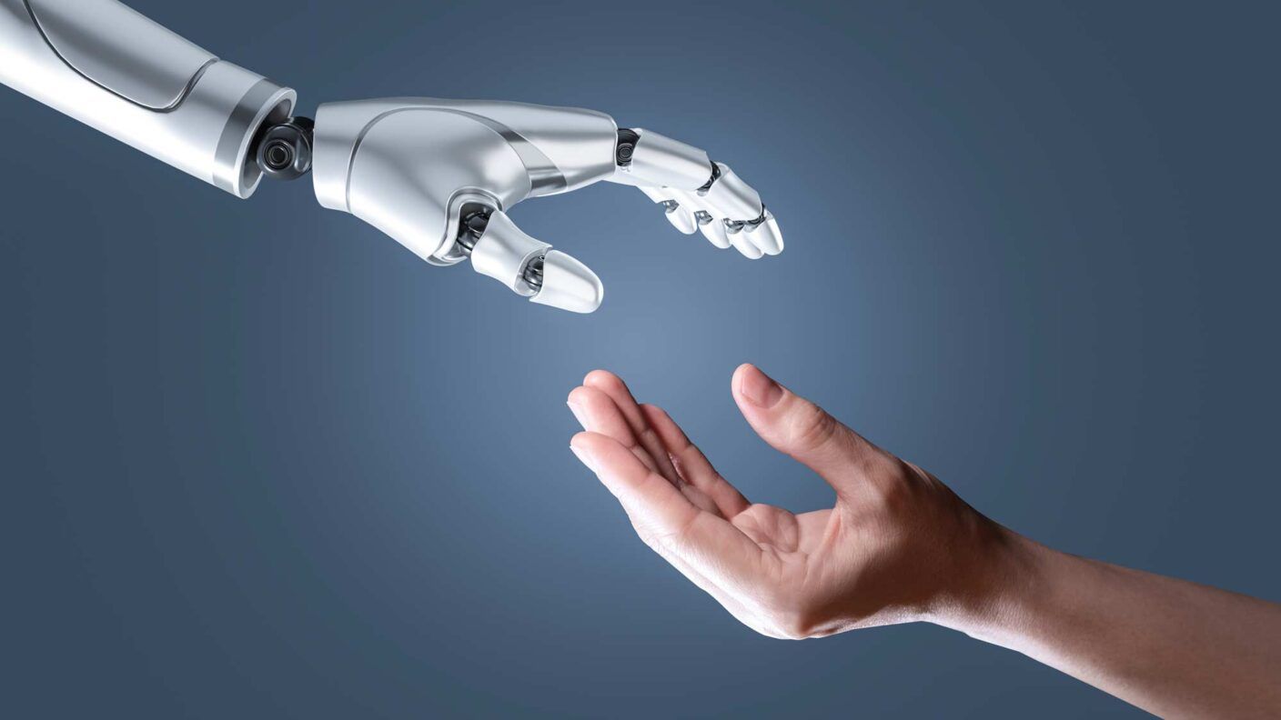 An illustration of a human hand reaching out to a robotic hand.