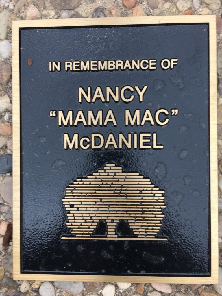 A plaque that reads "In Remembrance of Nancy 'Mama Mac' McDaniel"