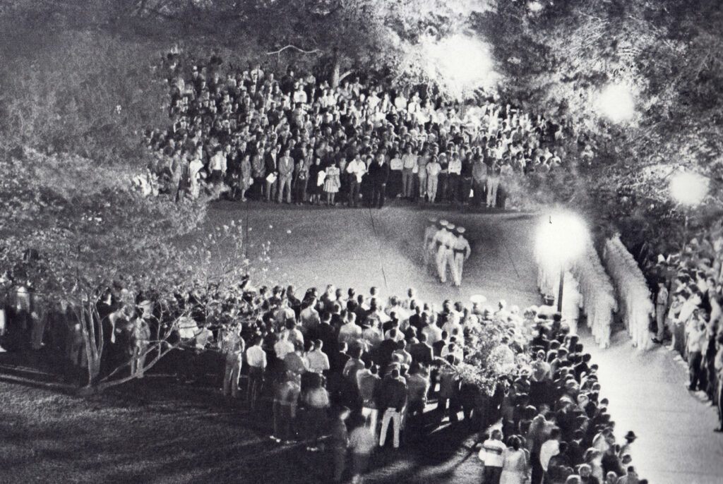 Unusual lighting conditions made this 1984 photo of Silver Taps possible. ‘They were doing some construction on the Academic Building at the time, so it wasn't completely dark as it traditionally is. Without that, it would have been impossible to get this image,’ said former Battalion photographer Peter Rocha ’85. For the Ross Volunteers, he said, ‘The stop-start style of marching they do also made it possible. Otherwise, they would have been a blur.'