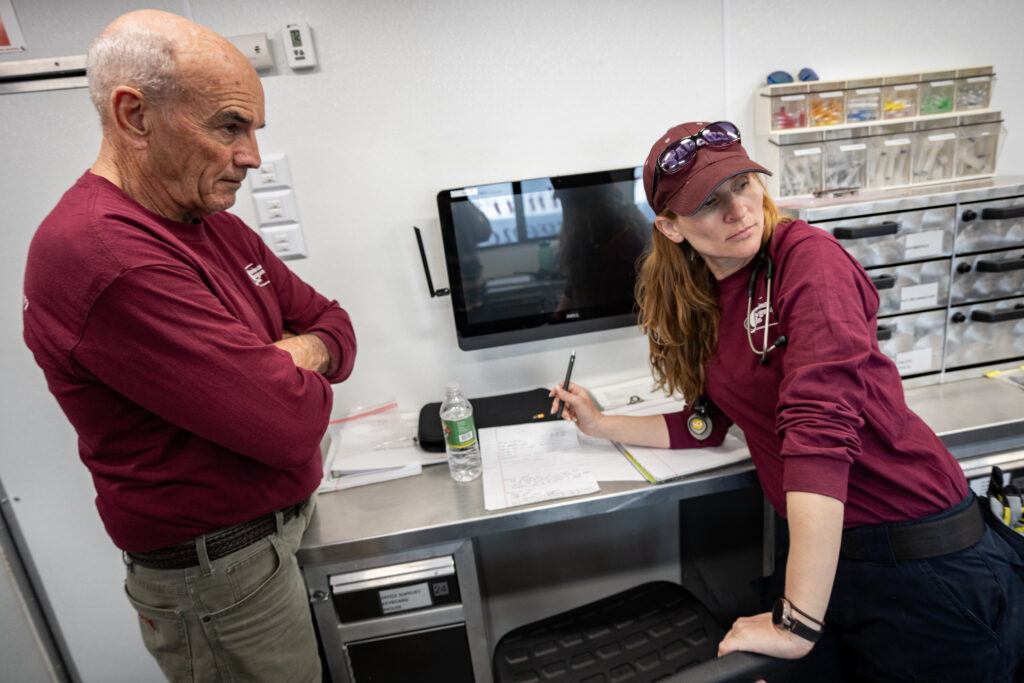 A photo of two members of the Veterinary Emergency Team in a mobile clnic.