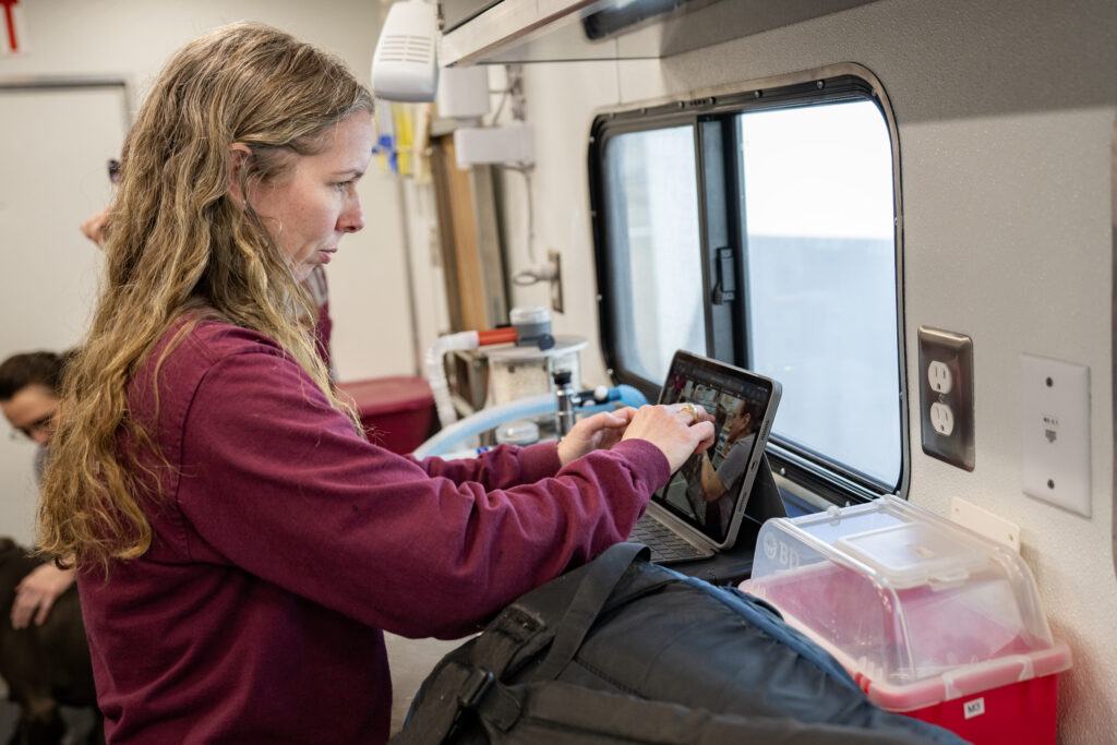 A photo of a member of the Veterinary Emergency Team working in a mobile trailer.