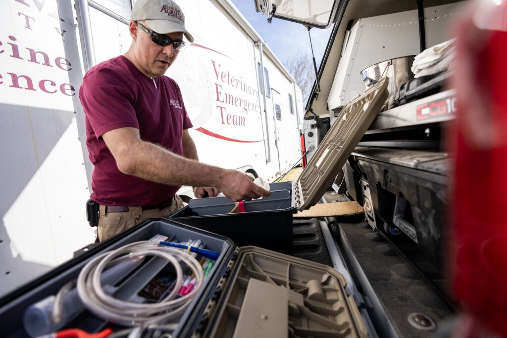 A photo of a member of the Veterinary Emergency Team setting up equipment.
