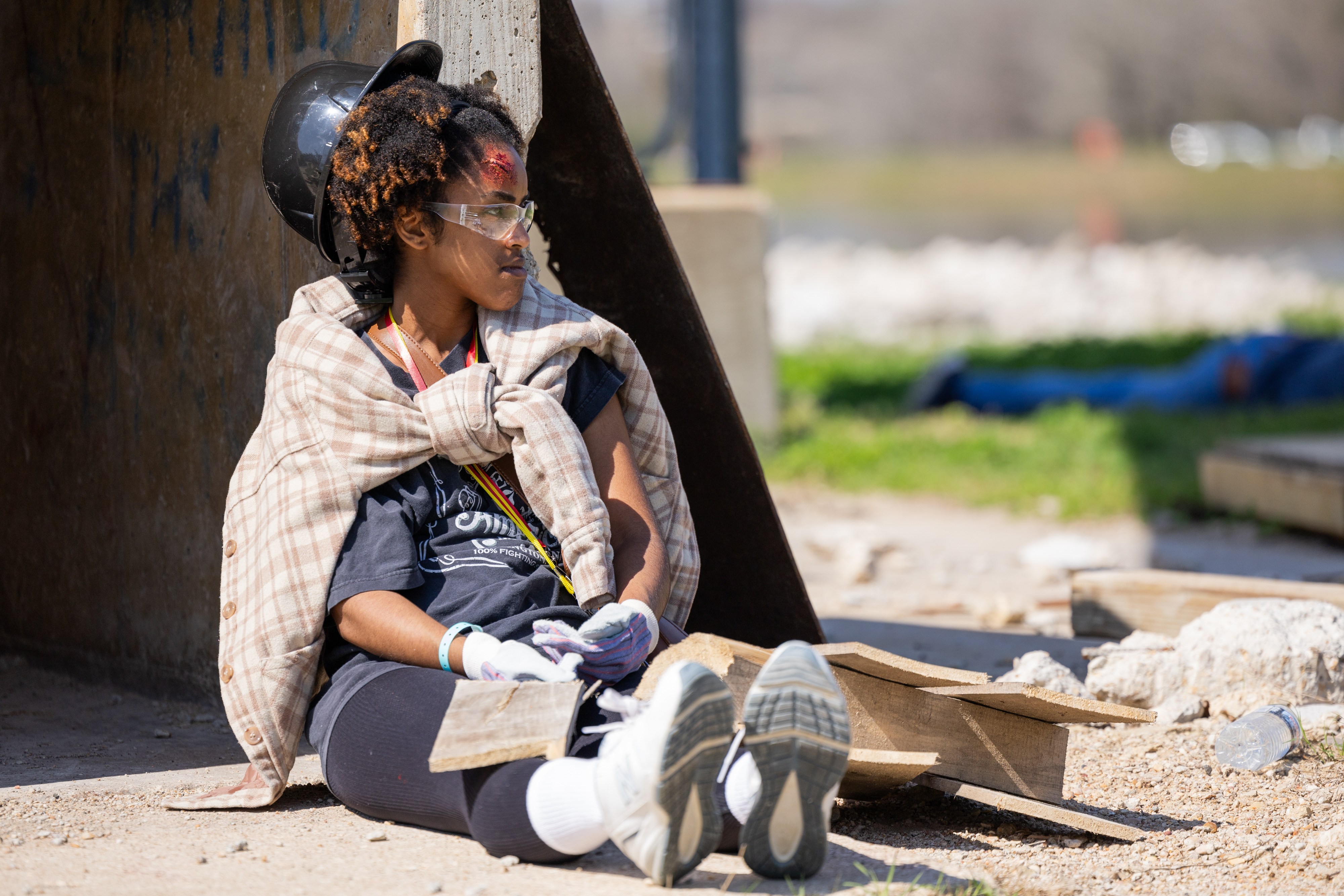 A photo of a student playing the role of a patient with a head wound during a disaster training simulation.