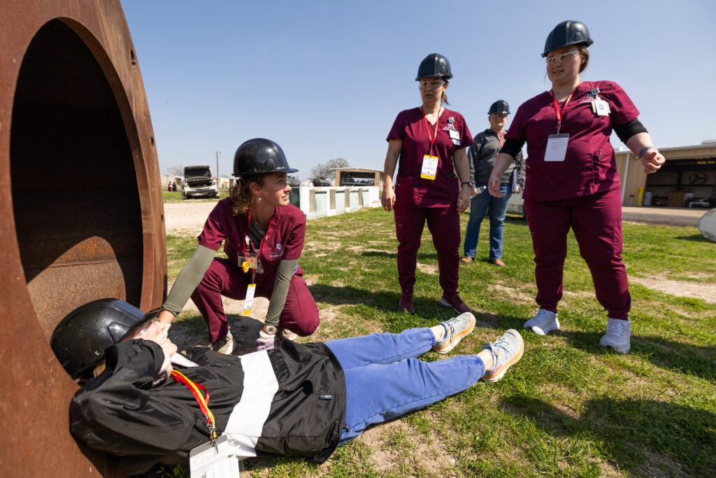 A photo of students tending to a victim during a mass disaster training exercise.