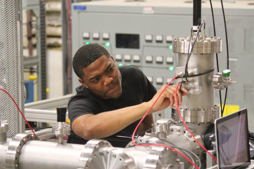 a worker adjusting the cyclotron
