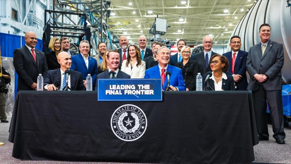 A photo of a group of people surrounding Texas Gov. Greg Abbott during a press event announcing the formation of the Texas Space Commission.
