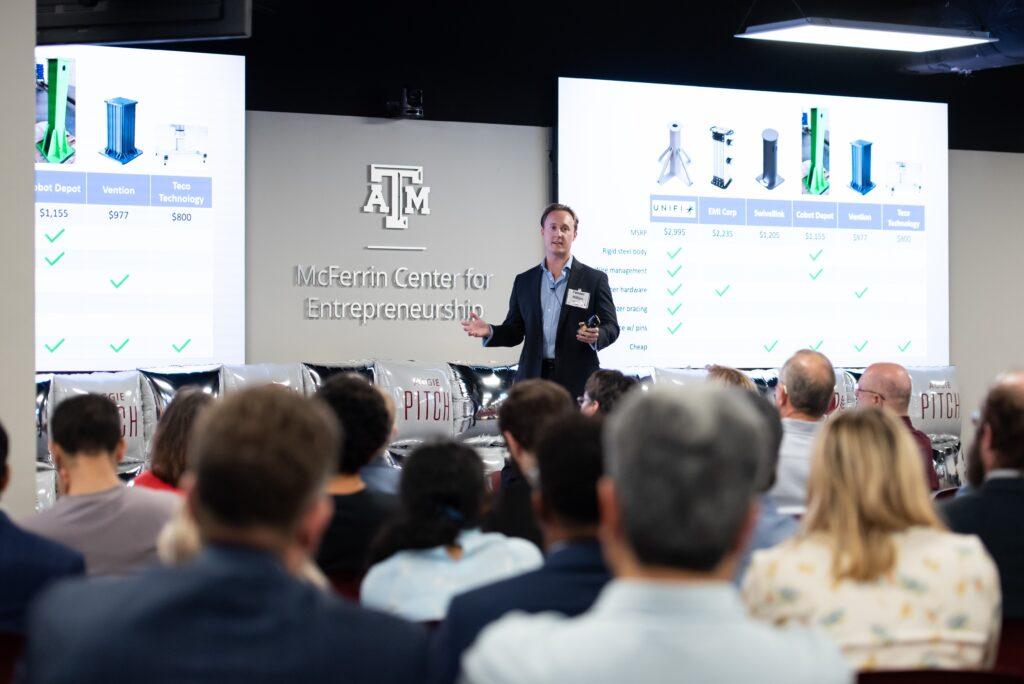 Tanner Hilton making his presentation before an audience at the Aggie PITCH competition.