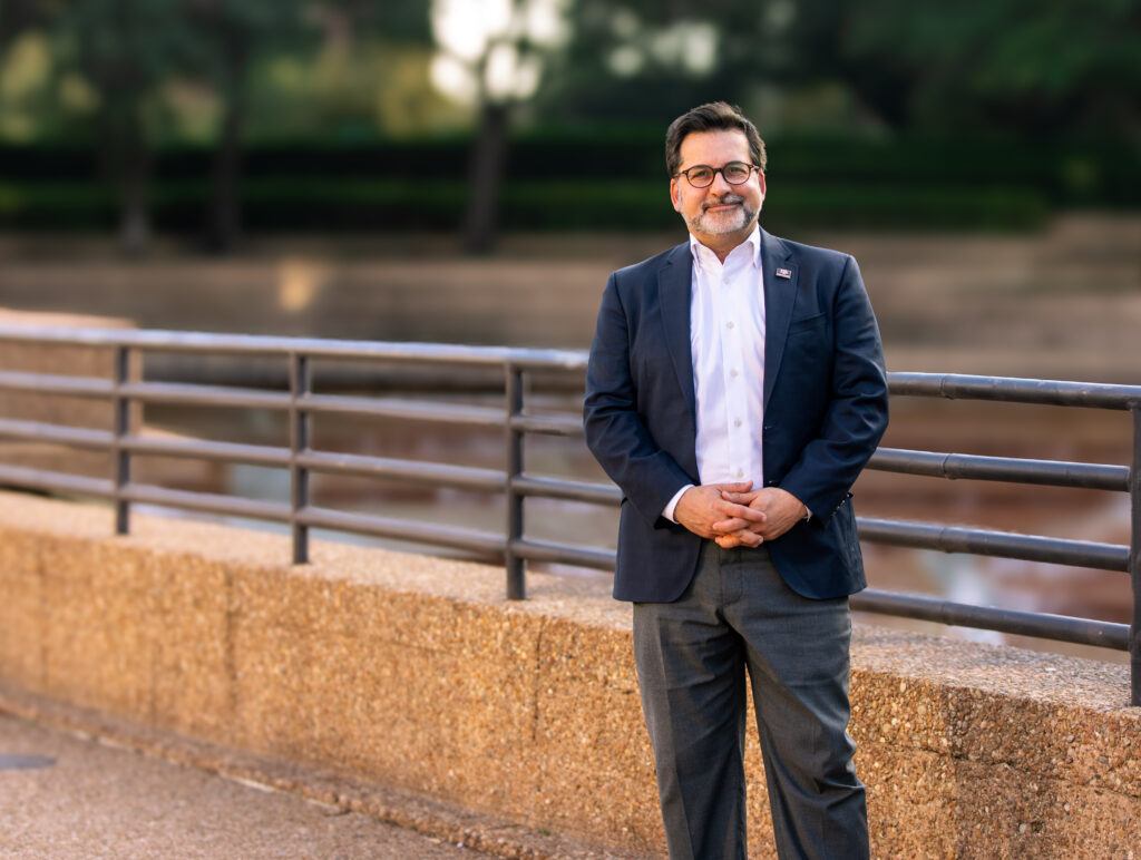 Portrait of Bobby Ahdieh standing outside with his hands clasped.